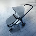 Modern Gray Patterned Stroller With Black Frame On Outdoor Paved Ground