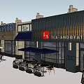 Modern Commercial Street Featuring Glass Facade Outdoor Seating And Shop Signs