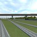 Railway Tracks With Overhead Bridge Structure And Green Grass Field Under Clear Sky