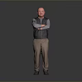 Man Standing with Arms Crossed in Black Vest Gray Shirt Brown Pants Gray Gradient Background