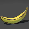Ripe Yellow Banana With Brown Spots Isolated On Gray Background