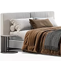 Modern Bedroom Bed With White And Brown Pillows Gray Knit Blanket And Round Side Table
