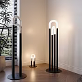 Modern Interior Floor Lamp With Curved White Light And Black Base On Wooden Floor