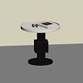 Round Side Table Featuring White Tabletop Black Geometric Base With Silver Balls And Book