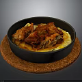 Braised Red Meat with Cabbage Over Yellow Mashed Potatoes in Black Bowl on Brown Mat