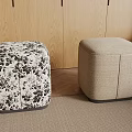 Two Stylish Stools with Floral Pattern and Beige Upholstery in Modern Room with Wooden Wall