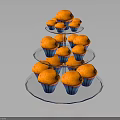 Three Tiered Transparent Glass Cupcake Stand Holding Multiple Orange Cupcakes