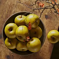 Ceramic Bowl Filled With Green Apples On Wooden Table With Branches And Red Flowers