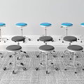 Wheeled Stools With Blue And Gray Seats Against White Wall On Gray Carpet