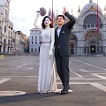 Couple In Wedding Gown And Suit Waving At Venetian Plaza