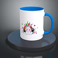 White Mug With Blue Rim Handle And Colorful Unicorn Stars Design On Black Circular Base