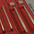 Golden Decorative Door Handles on Red Background With Intricate Patterns And Classic Design