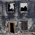 Burned Building Exterior With Damaged Walls Broken Windows Fallen Bricks And Debris At Entrance