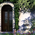 Arched Entrance Gate With Green Ivy Stone Wall Flower Beds And Decorative Fountain