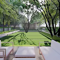 Modern Residential Landscape With Lush Lawn Shade Trees And Outdoor Seating Area