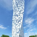 Twisted White Hotel Building With Triangular Geometric Patterns On Facade Against Blue Sky And Clouds 3d model