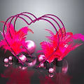 Pink Feather Plants In Heart Shaped Frame With Pink Spheres And Black Base