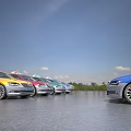Colorful Cars Including Taxi Parked On Open Road With Blue Sky Background