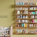 Motherhood Store Interior With Baby Crib And Pegboard Shelves Of Baby Products