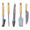 Stone Outdoor Cooking Station With Black Countertop Firewood And Cooking Utensils
