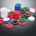 Colorful Poker Chips for Card Games Stacked and Scattered on Black Surface