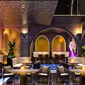Modern Bar Interior Featuring Chandelier Arched Structures Large Screens Stage And Plant Decorations