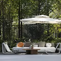 Outdoor Sofa with White Parasol Green Plants and Decorative Pillows in Garden