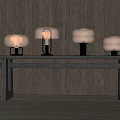 Four Copper Table Lamps On Dark Wooden Table With Dark Wooden Wall Background