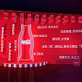 Coca-Cola Photo Check-in Spot Featuring Red Background Large Neon Bottle And Red Boxes