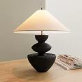 Modern Black Base Table Lamp With White Lampshade And Magazines On Wooden Table