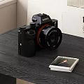 Sony Digital Camera As Daily Electrical Appliance On Black Wooden Table With Photo Album