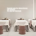 Modern Beauty Salon Interior With Treatment Beds White Linens And Pink Stools