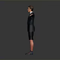 Man in suit jacket and tie with black shorts and purple sneakers standing arms outstretched