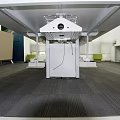 Large White Industrial Equipment with Black Circular Top and Metal Support Frames in Indoor Facility