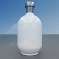 White Wine Bottle With Silver Cap On Gray Countertop Against Blue Sky