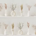 Decorative Vases with Dried Flowers on White Shelves Featuring Various Designs and Materials