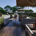 Garden Landscape Design With Lush Trees Yellow Seating And Paved Recreation Area