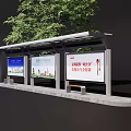 Bus Stop With Shelter And Advertising Boards Near Green Tree