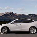 White Tesla Model Y SUV With Modern Exterior Black Roof And Alloy Wheels On Road
