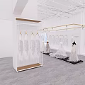 Modern Open Bridal Shop With White Wedding Dresses On Hangers And Display Area