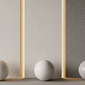 Sculptural Spheres Artwork With Textured Surfaces On Light Dark Illuminated Wall