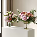 Pink Peonies White Roses With Green Leaves In Glass And Brass Vases On White Pedestal
