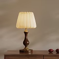 Table Lamp With White Lampshade Wooden Base Golden Accents And Red Decorative Items On Table