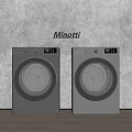 Two Silver Minotti Front Loading Washing Machines Against Gray Wall On Wooden Floor