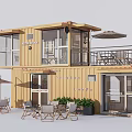 Yellow Two Story Container Building With Terrace Outdoor Seating Sun Umbrellas And Plants
