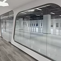 Modern Office Corridor Interior With Glass Partitions Bright Lighting And Wooden Flooring