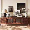 Vintage Wooden TV Stand With Circular Accents Glass Doors And Decorative Items On Top
