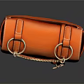 Orange Leather Saddle Bag With Metal Chain Lock Clasp And Textured Surface Design