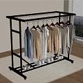 Stainless Steel Clothes Rack With Hanging Clothes And Shoes On Carpet In Room