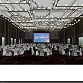 Elegant Banquet Hall With Hanging Chandeliers Large Screen And White Tablecloth Tables On Red Carpet